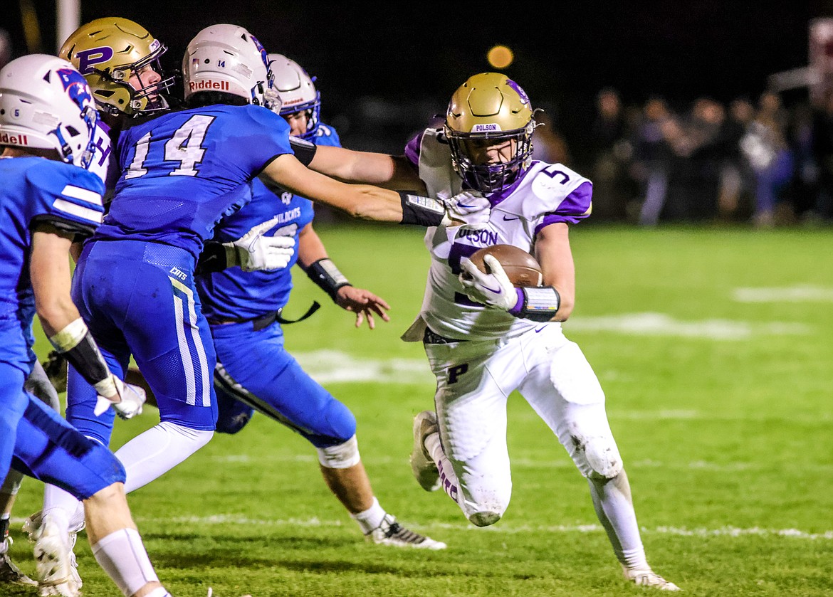 Polson junior Logan Smith pushes past the defense in Columbia Falls on Friday. (JP Edge/Hungry Horse News)