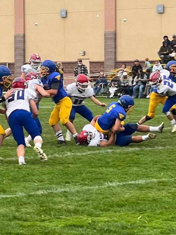 Bobcats lineman Carter McLees (50) helps blockers try to open a hole during Superior's game with the Victor Pirates this past Saturday in Victor. (Photo by Kami Milender)