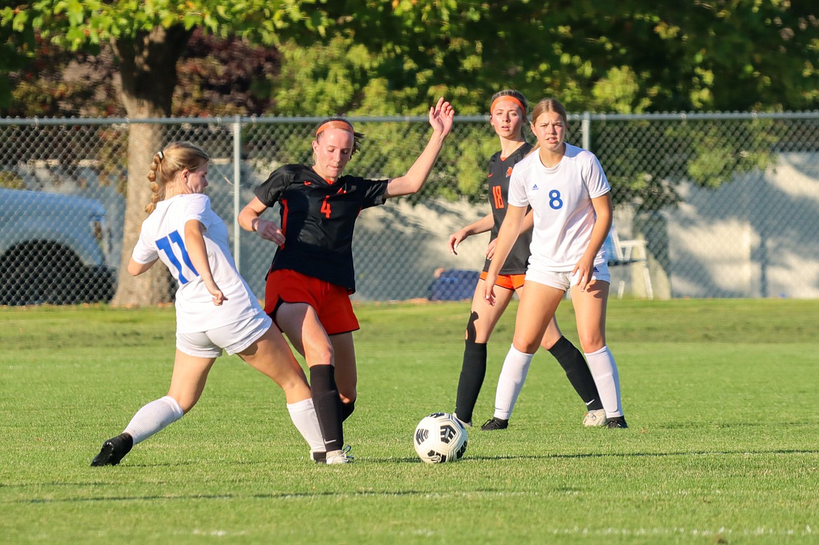 Photo by JERRY VICK
Kylie McCamly (11) of Coeur d'Alene and Teagan Chatterton (4) of Post Falls vie for the ball Monday at Post Falls High. Looking on is Savannah Ross (18) of Post Falls and Rachel Corette (8) of Coeur d'Alene.