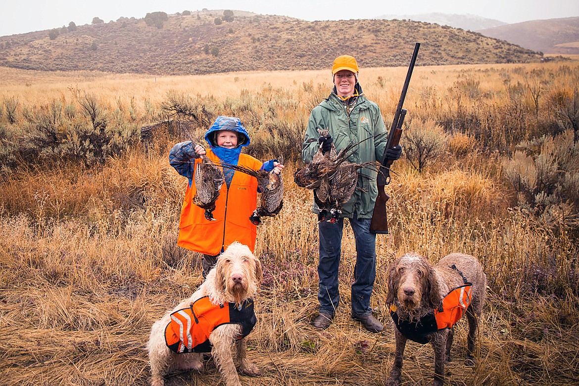Youth pose with their pheasants and hunting dogs at Southeast Idaho Fish and Game's annual Family Outdoor Festival.