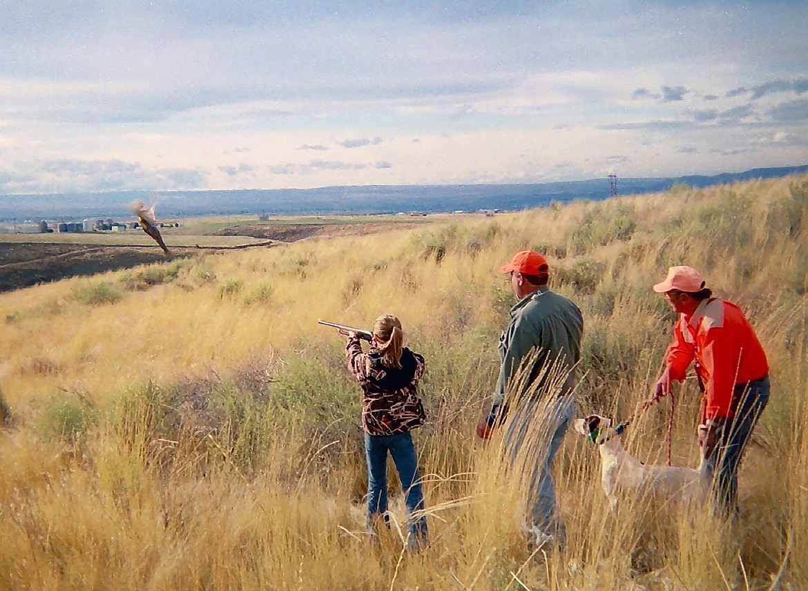 A young hunter shoots at a pheasant in flight in January 2007 during a 
youth pheasant hunt.