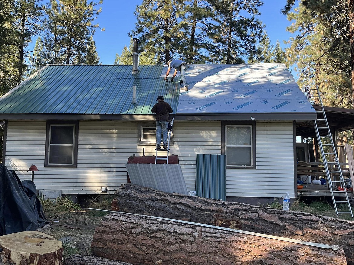 Remnants of the tree lay in the foreground, and behind it are the newly laid roof sections ready for sheets of tin.