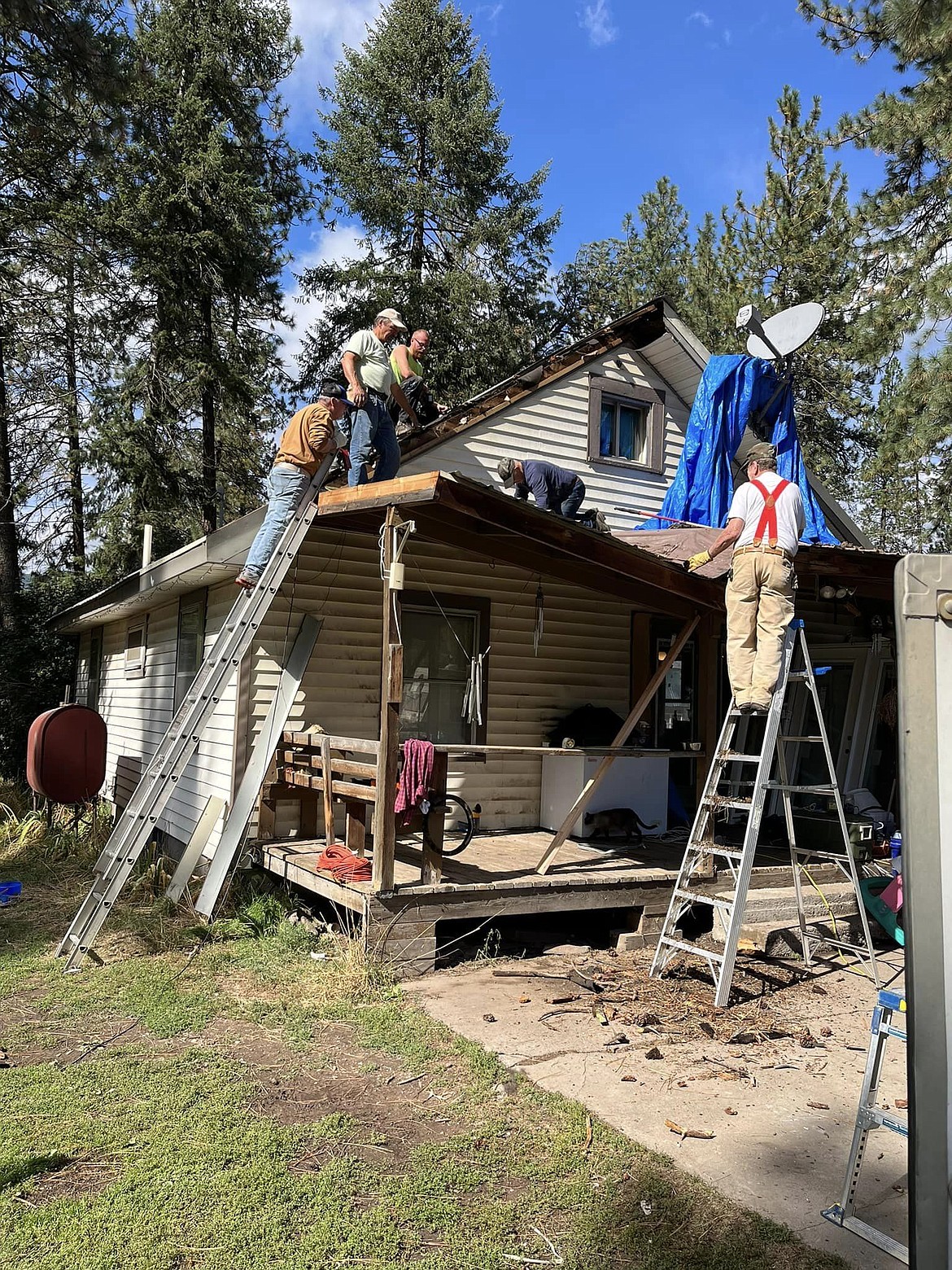 A group of volunteers from New Day Fellowship in St. Regis made up the work crew that was led by local contractor Terry Messenbrink. From left, Pastor Morris Hill on the ladder, Russell Cleveland, Shawn Yount and Scott Burrows on the other ladder. (Photo provided)