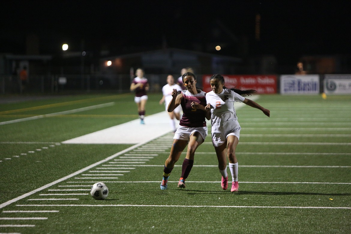 Moses Lake’s Anna Ribellia fights for possession of the ball against a Davis defender.