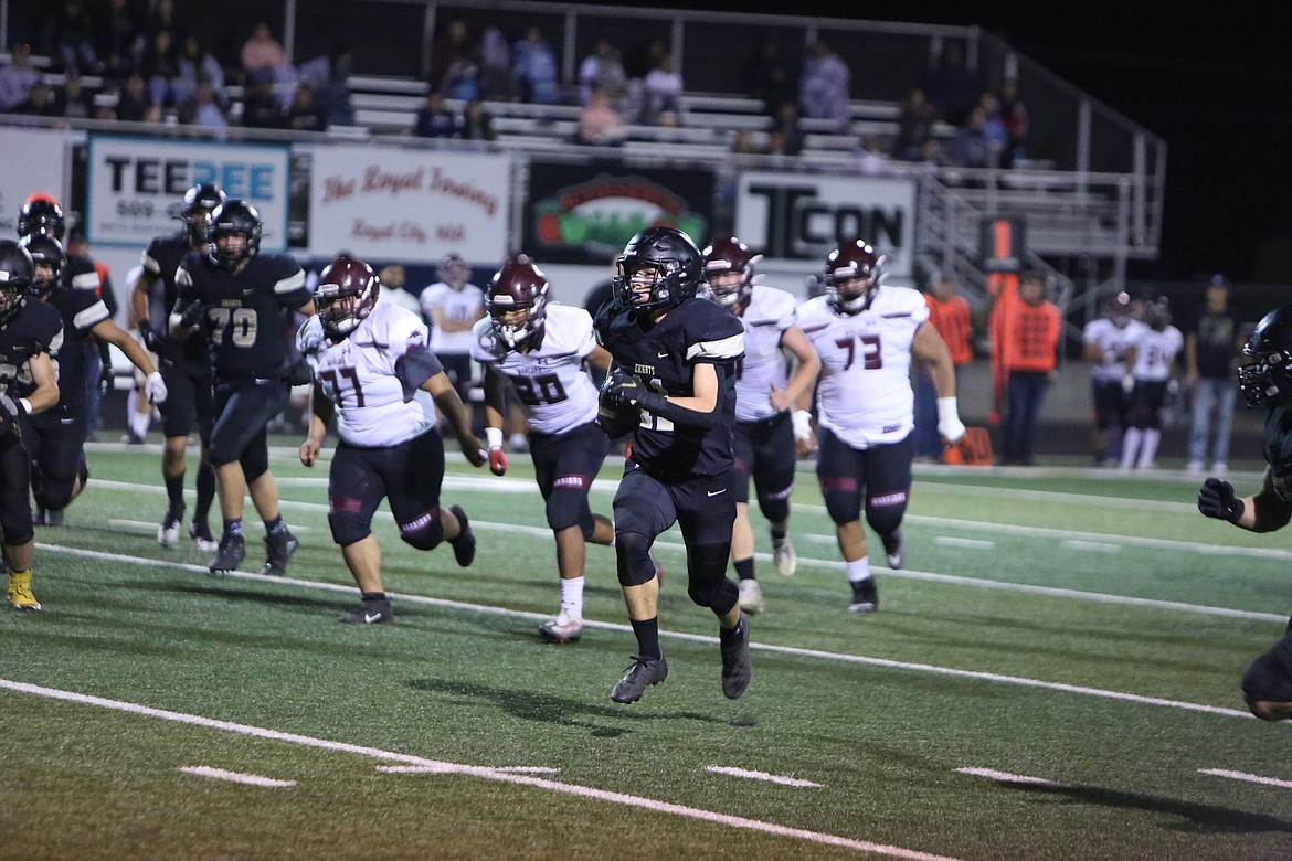 Royal’s Lance Allred escapes past Wahluke defenders en route to a 50-yard touchdown run in the Knights’ 51-3 win over the Warriors.