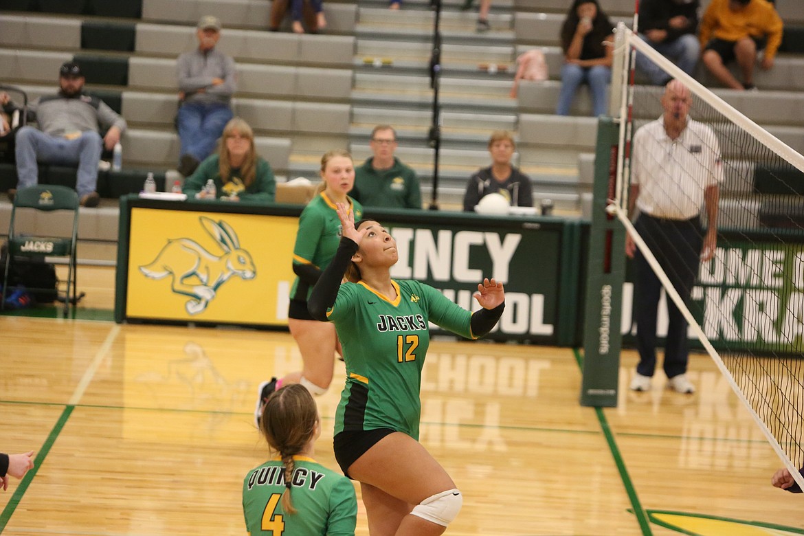 Quincy’s Alyana Quintanilla leaps in the air in preparation to spike the ball over the net.