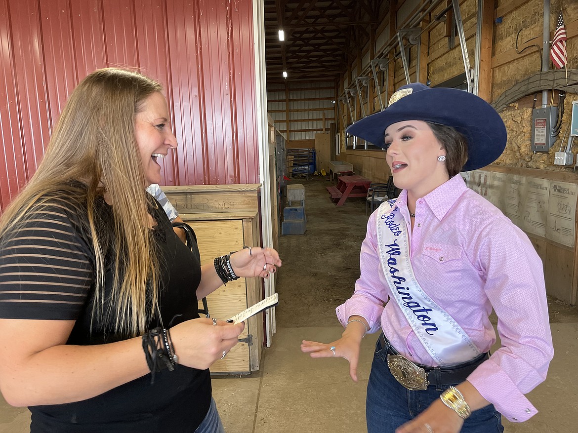 Heidi Tracy (right) finished explaining to Miss Rodeo Washington Lexy Hibbs about some of the horses she will ride on Sunday as part of the Pink 50 Horses Challenge, which asks riders to ride 50 different horses in October to raise breast cancer awareness.