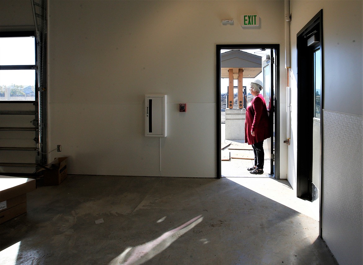 Kootenai Humane Society Executive Director Debbie Jeffrey looks out one of the doors of their new shelter under construction on Ramsey Road on Tuesday.