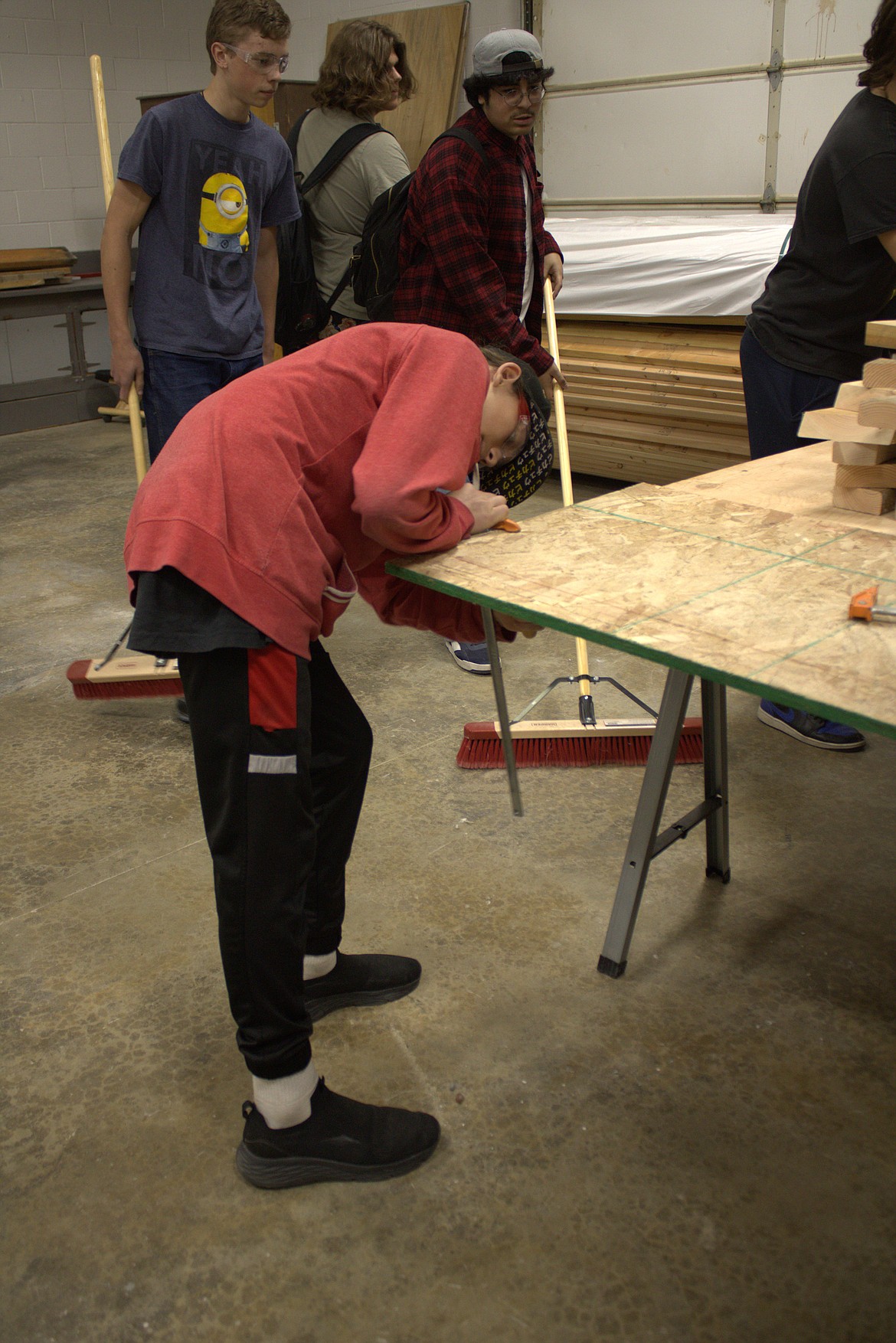 Students in Stephen Wimer's Residential Carpentry class at Sandpoint clean up at the end of class.