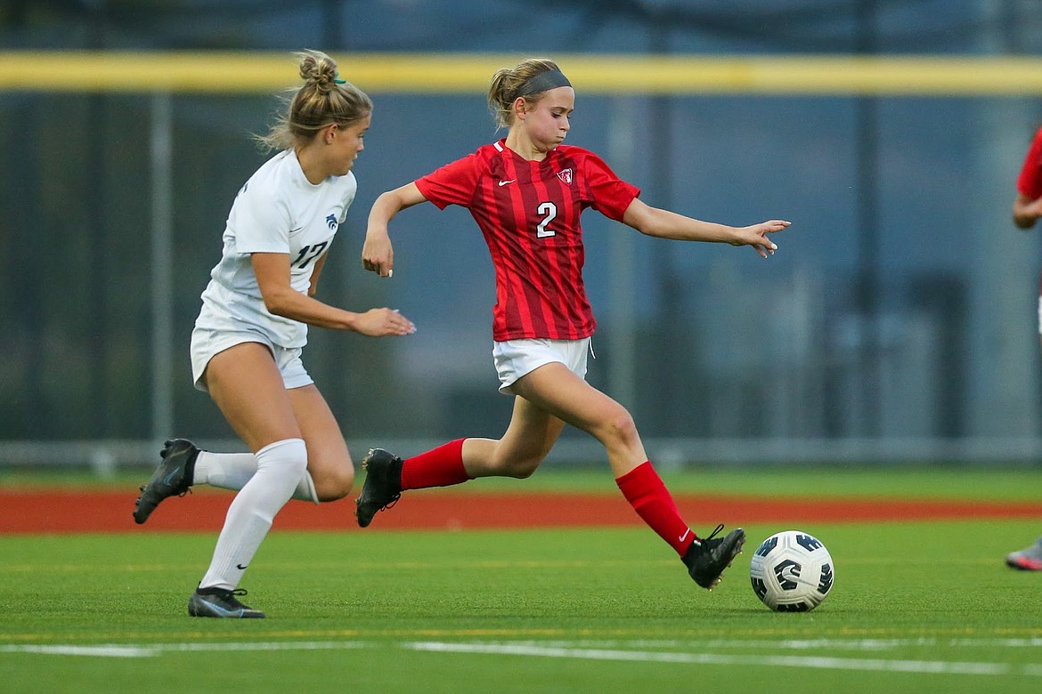 Sandpoint sophomore Marlee McCrum attempts to fend off Lake City junior Taylor Miller.