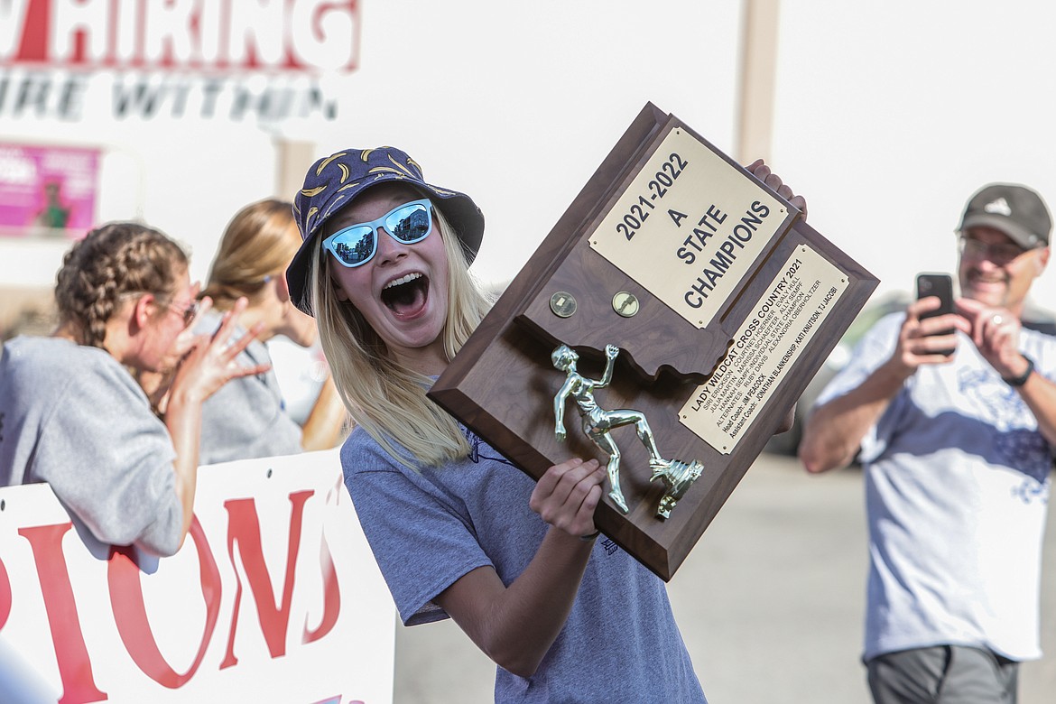 Siri Erickson holds last year’s state championship trophy. (JP Edge photo)