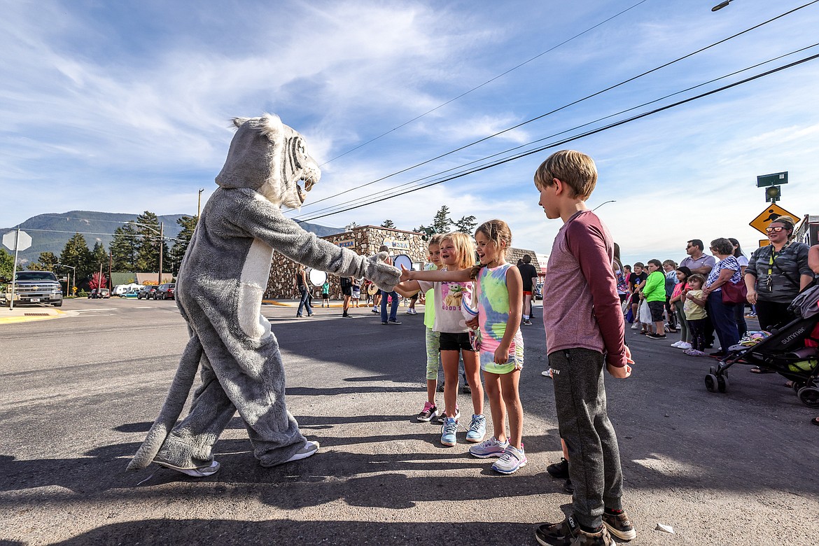 The Wildcat mascot greets kids in the crowd at the homecoming parade. (JP Edge photo)v