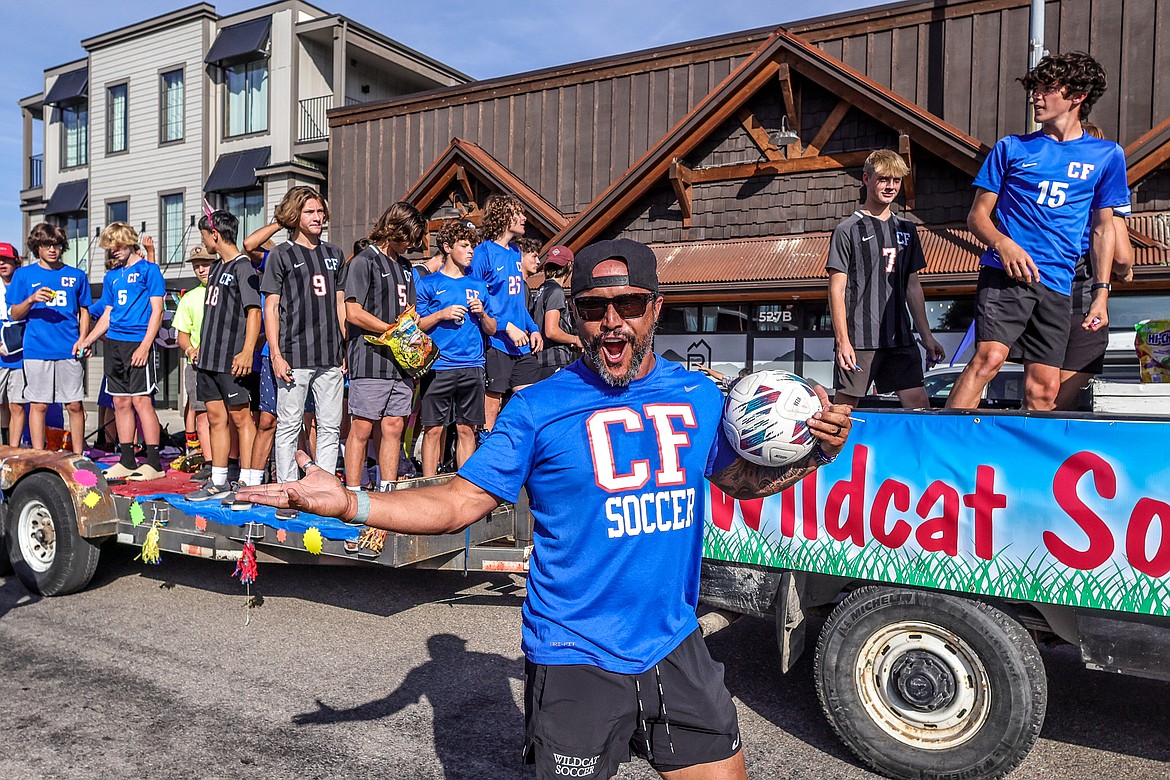 Boys soccer coach O’Brien Byrd gets the crowd going at the homecoming parade on Wednesday. (JP Edge photo)