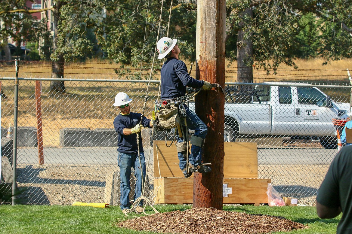 Sheldon Kosa, left, and Carson Fisk, right, represented Grant PUD at the Washington State Pole Top Rescue Competition.