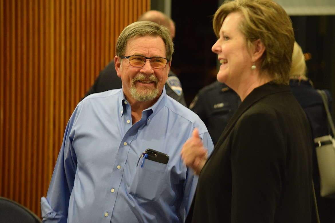 Moses Lake business owner David Skaug talks with City Manager Allison Williams following his appointment to the city council at a special meeting on Tuesday.