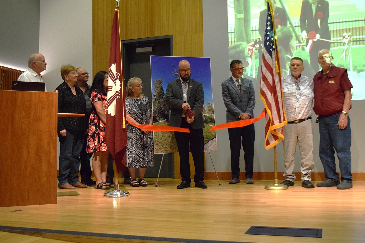 Moses Lake Mayor Don Myers formally cuts the ribbon during a ceremony at the Moses Lake Civic Center to mark the 40th anniversary of the sister city relationship with Yonezawa, Japan. The ceremony was livestreamed to and from Yonezawa, where Mayor Masaru Nakagawa also cut a ribbon to mark the occasion.