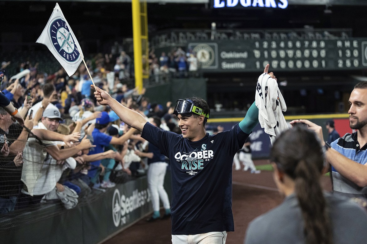 Seattle Mariners' Sam Haggerty celebrates after the team's baseball game against the Oakland Athletics Friday in Seattle. The Mariners won 2-1 to clinch a spot in the playoffs.