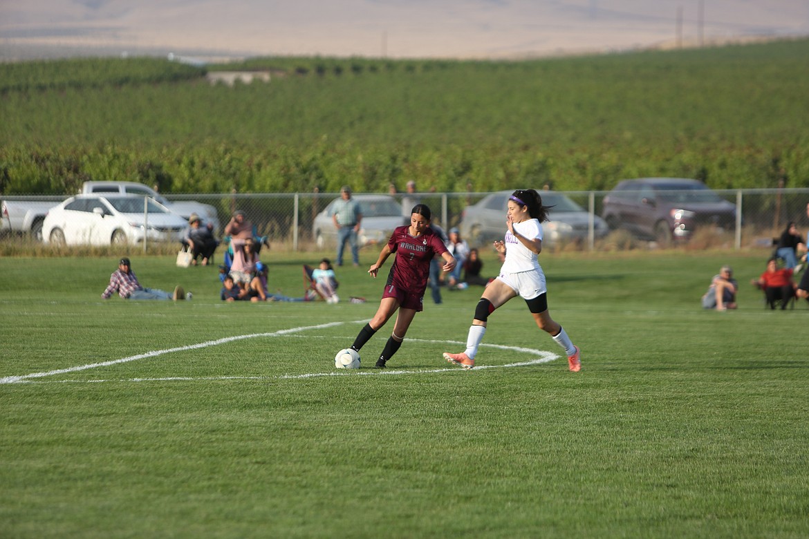 Wahluke sophomore Maria Barajas fights off an incoming Connell player to keep possession of the ball.