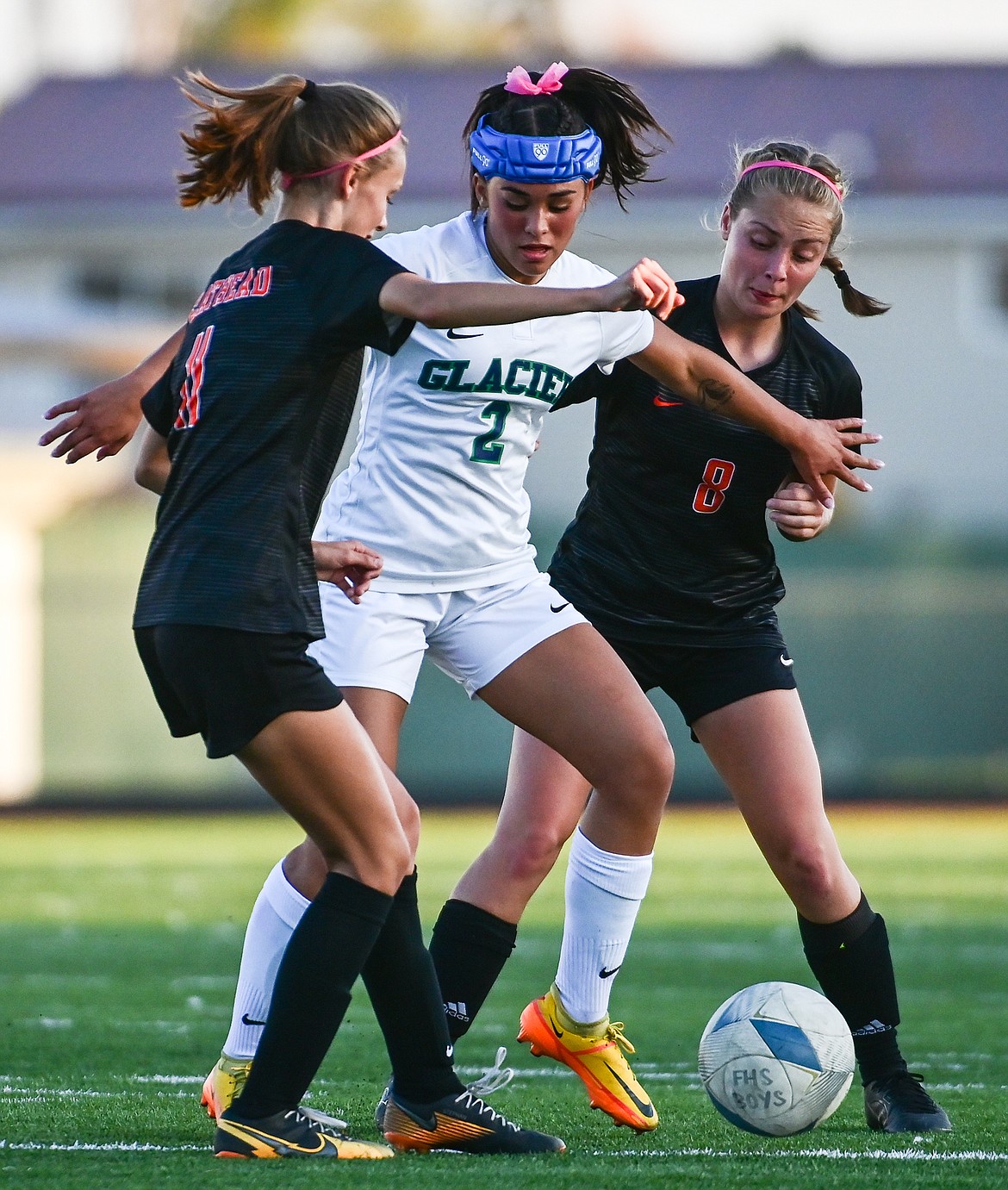 Glacier's Calista Wroble (2) battles for possession with Flathead's Mia Stephan (11) and Isla Alexander (8) at Legends Stadium on Thursday, Oct. 6. (Casey Kreider/Daily Inter Lake)