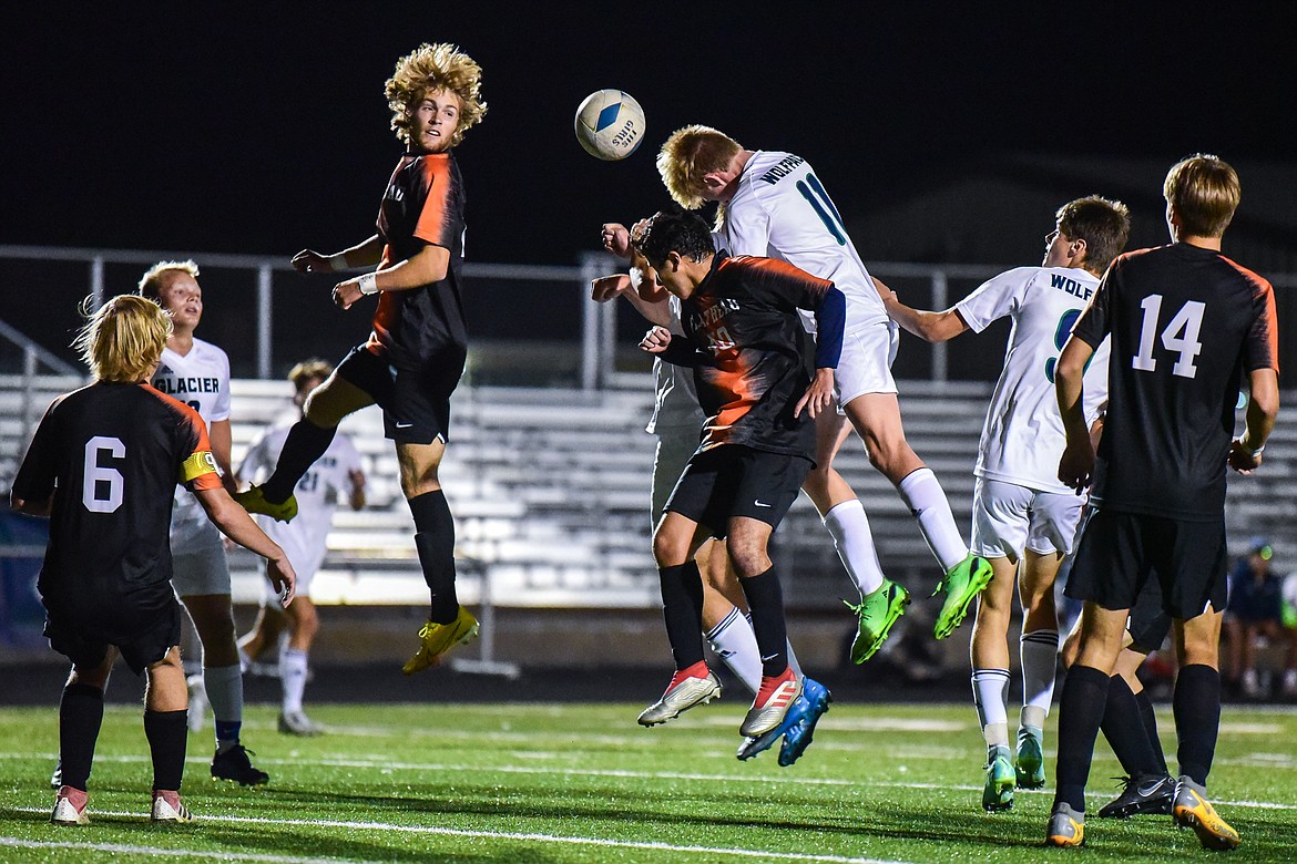 Glacier's Liam Ells (11) battles for a header off a corner kick against Flathead's Landen Saraceno (10) and Matthew Sanchez (40) at Legends Stadium on Thursday, Oct. 6. (Casey Kreider/Daily Inter Lake)