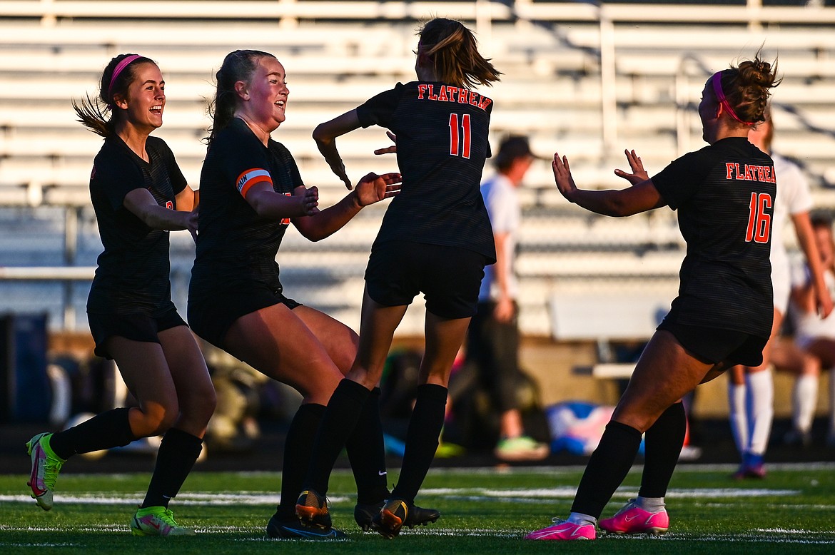 Flathead's Fiona Coulter (15, second from left) celebrates with teammates after her goal in the first half against Glacier at Legends Stadium on Thursday, Oct. 6. (Casey Kreider/Daily Inter Lake)