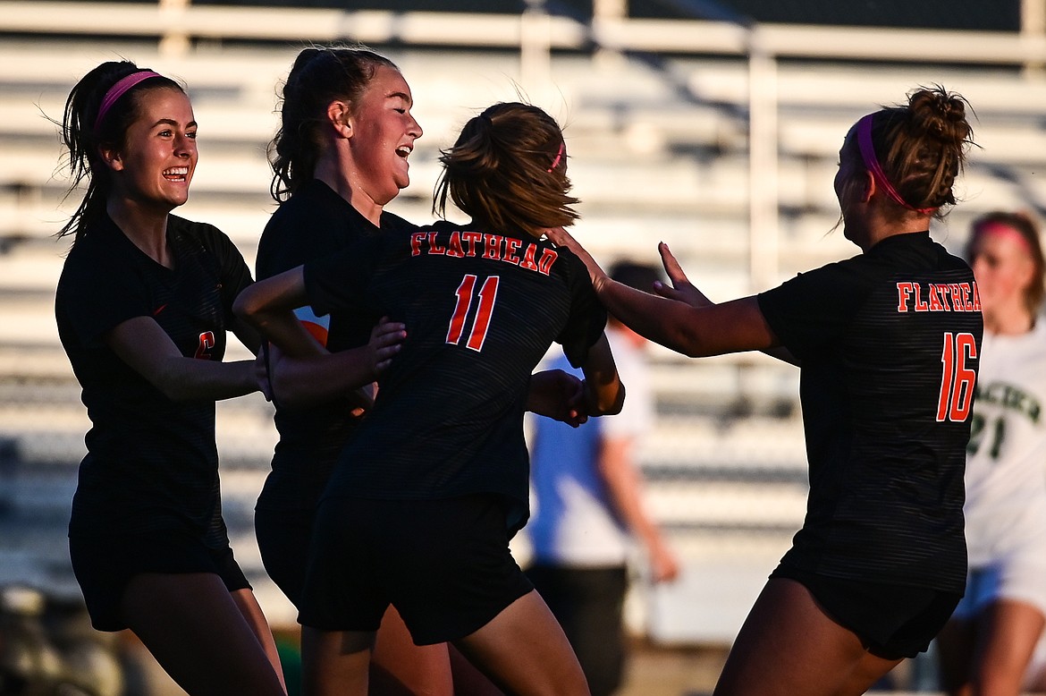 Flathead's Fiona Coulter (15, second from left) celebrates with teammates after her goal in the first half against Glacier at Legends Stadium on Thursday, Oct. 6. (Casey Kreider/Daily Inter Lake)