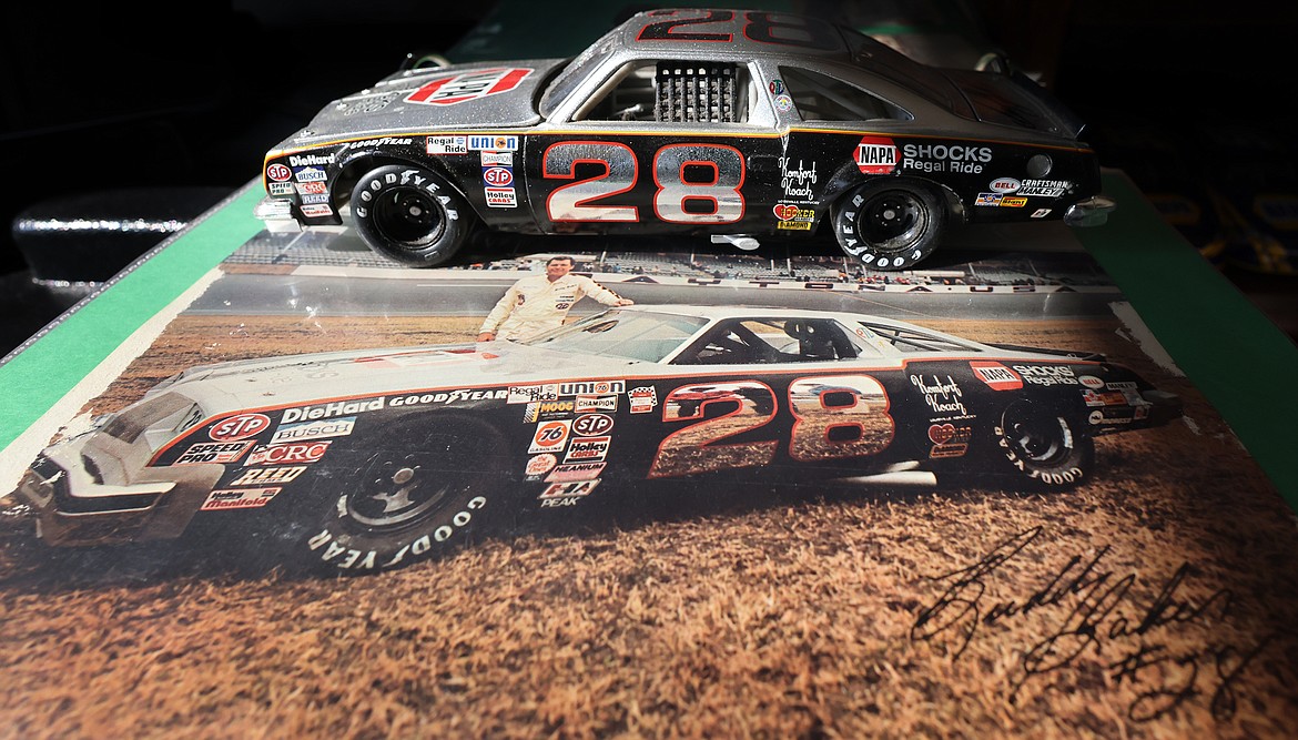 A miniature car and autographed photo from Buddy Baker are part of Kevin Bach's NASCAR memorabilia collection. (Jeremy Weber/Daily Inter Lake)