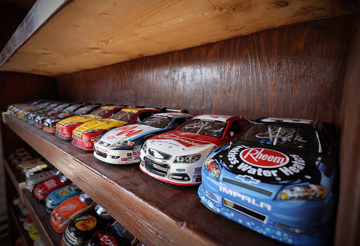 Dozens of miniature NASCAR racers, many signed, line the shelves in the garage of Kalispell collector Kevin Bach. (Jeremy Weber/Daily Inter Lake)