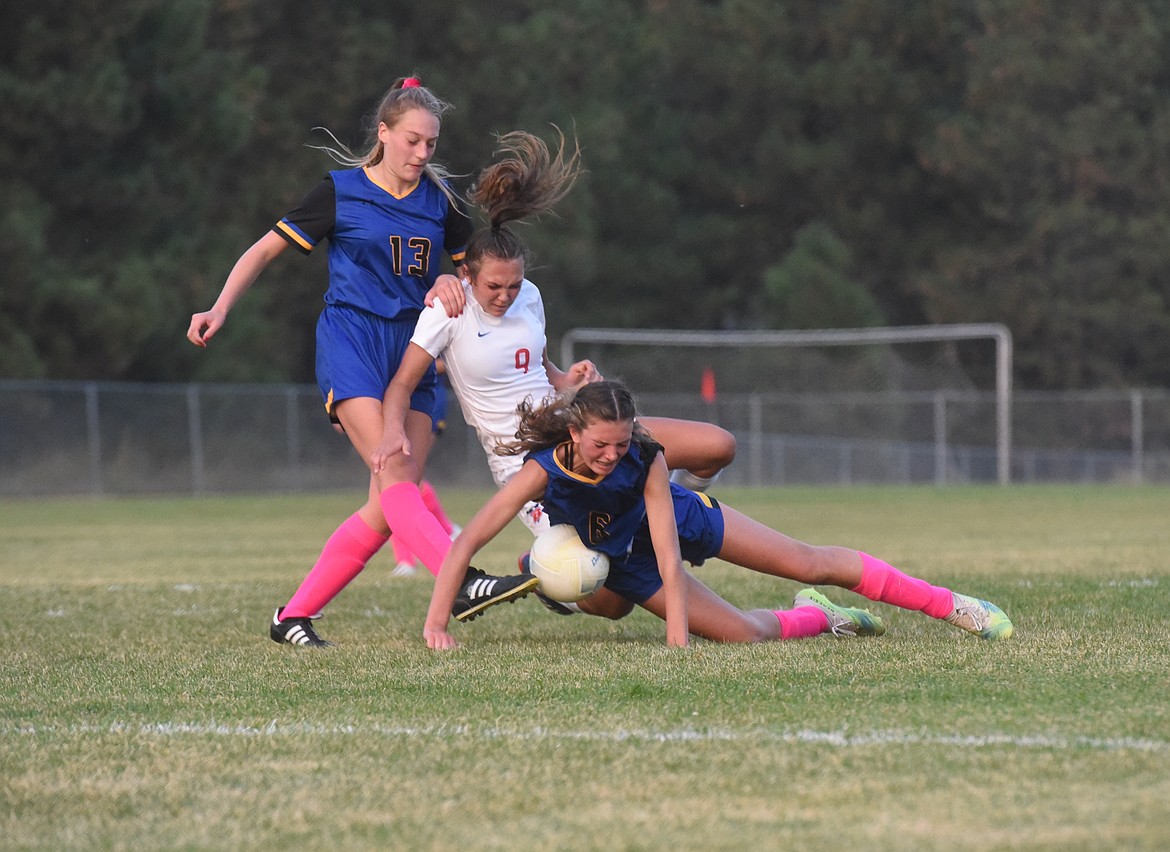 Libby soccer players Kylee Derryberry (13) and Bergen Fortner (6) collide with a Bigfork player during the Thursday, Oct. 6 game at J. Neils Memorial Park. (Scott Shindledecker/The Western News)