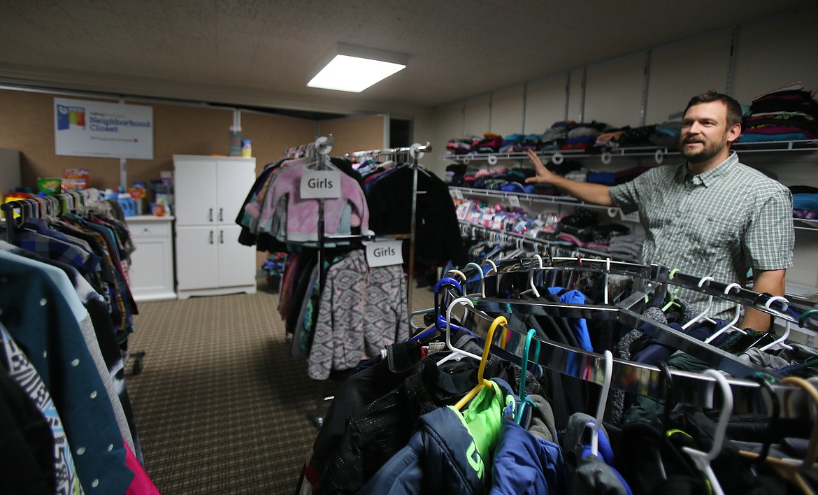 Pastor McLane Stone of First Presbyterian Church on Wednesday shows the new Neighborhood Closet in the church's basement to help schoolchildren in need. Stone and his family came to Coeur d'Alene in September.