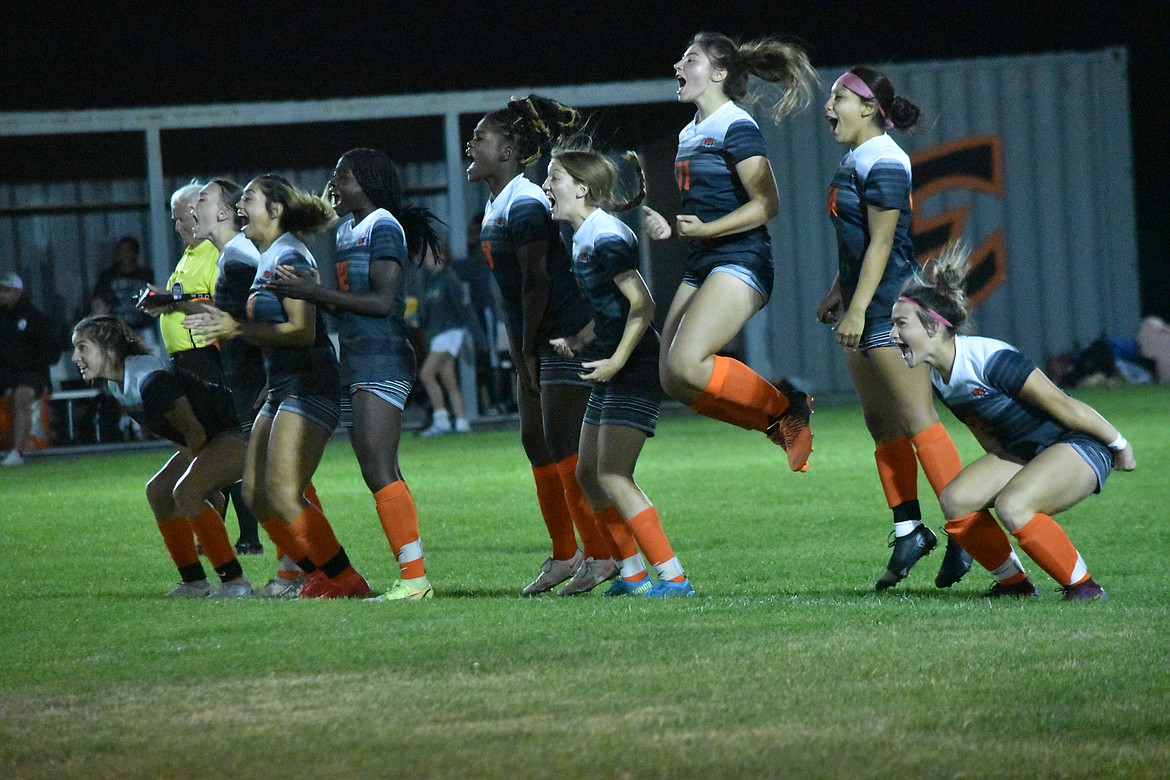 The Ephrata girls soccer team jumps and celebrates as a teammate makes a goal during the penalty kick shootout against Selah on Oct. 6.