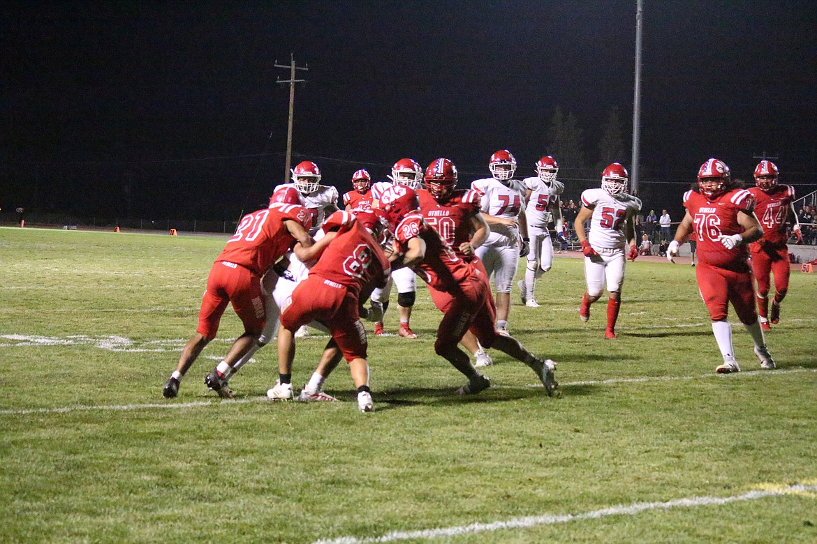 Othello defenders swarm a Prosser running back in Othello’s 28-17 win Friday night.