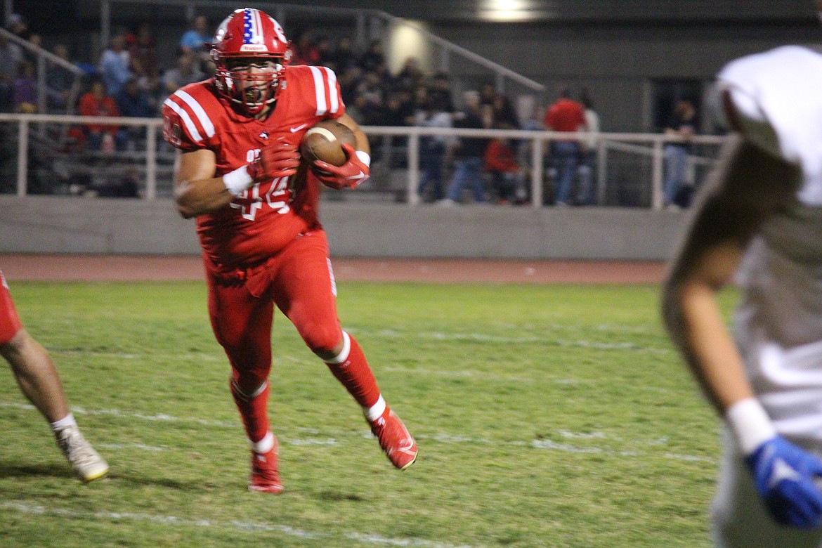 Julian Alegria (44) runs the ball upfield in Othello’s 28-17 win over Prosser Friday.