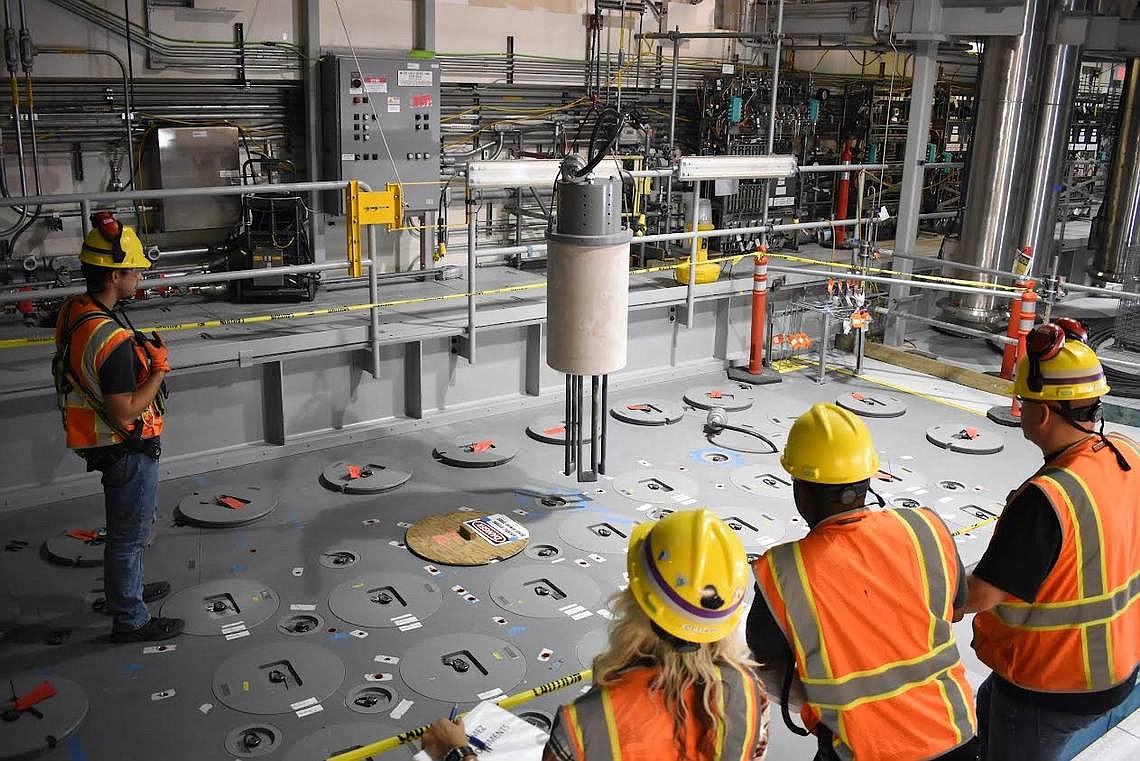 A Hanford vitrification plant crew installs one of 18 startup heaters into the lid of the first melter to begin to be heated up inside the Low Activity Waste Facility. (Courtesy/Bechtel National)