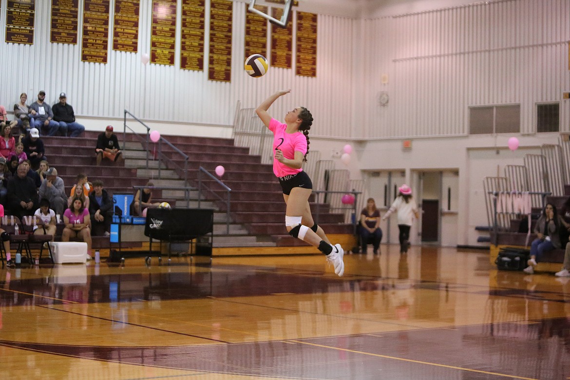 Moses Lake junior Raegen Hofheins hovers in the air while performing a serve in Moses Lake’s 3-1 win over Eisenhower on Thursday.