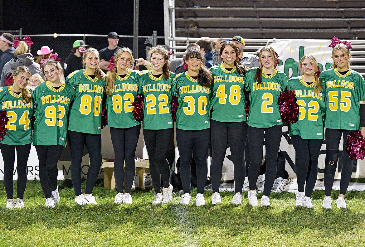 The Whitefish cheerleaders smile for a photo after the Bulldog football game on Friday night. (Whitney England/Whitefish Pilot)