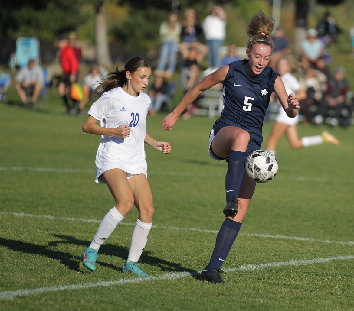 JASON ELLIOTT/Press
Lake City senior midfielder Delaney Moczan (5) plays the ball off her foot during the first half of Tuesday's 5A Region 1 girls soccer championship. Defending is Coeur d'Alene senior defender Berkley Owens.