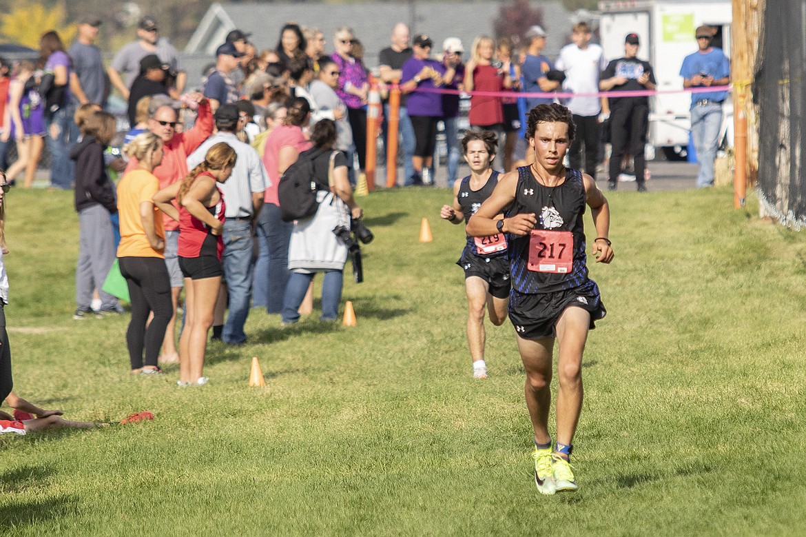 Mission Bulldog runners Robbie Nuila and Zoran LaFrombois finish second and third during the Mission Shadow Duels hosted at the Silver Fox Golf Course in Pablo on Saturday. (Rob Zolman/Lake County Leader)