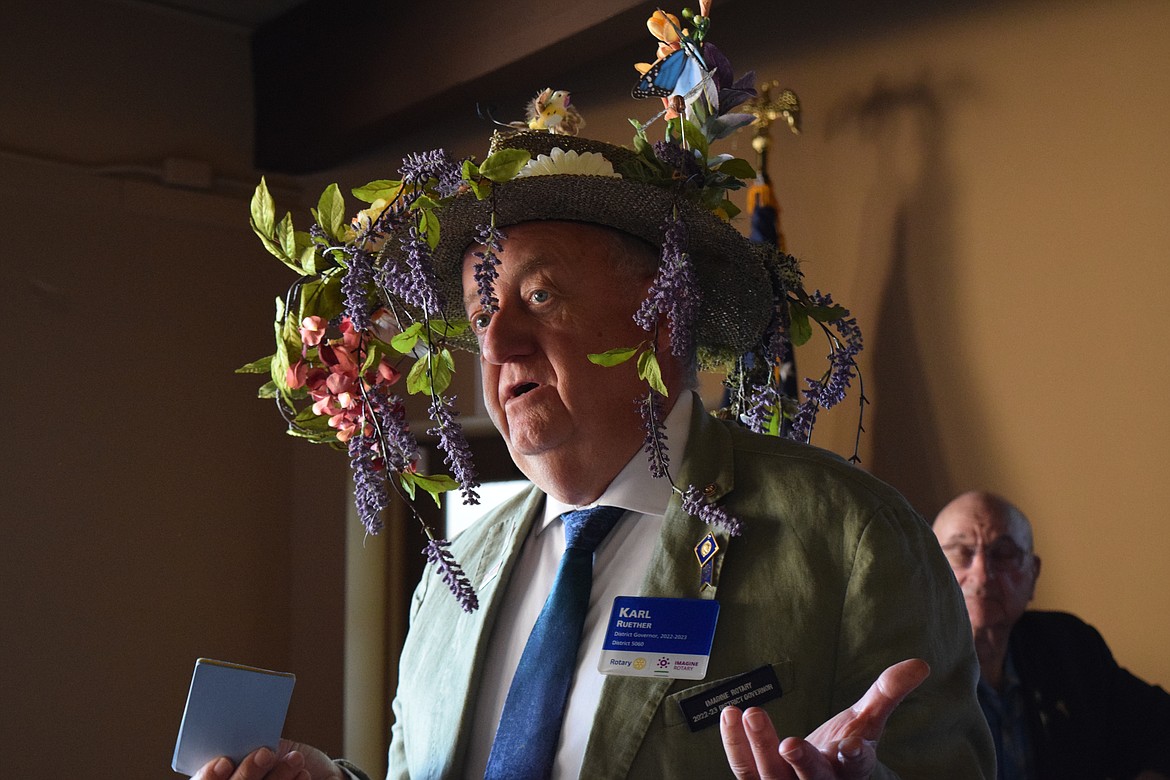 Karl Reuther, the Rotary Club’s district manager for Central Washington and south-central British Columbia, speaks to members of the Rotary Club of Moses Lake at their regular weekly luncheon on Tuesday. The hat is part of an effort to encourage club members to plant flower gardens to aid pollinators like bees and butterflies. “Everybody can do that,” Reuther said. “A little dirt, a little water, a little love.”