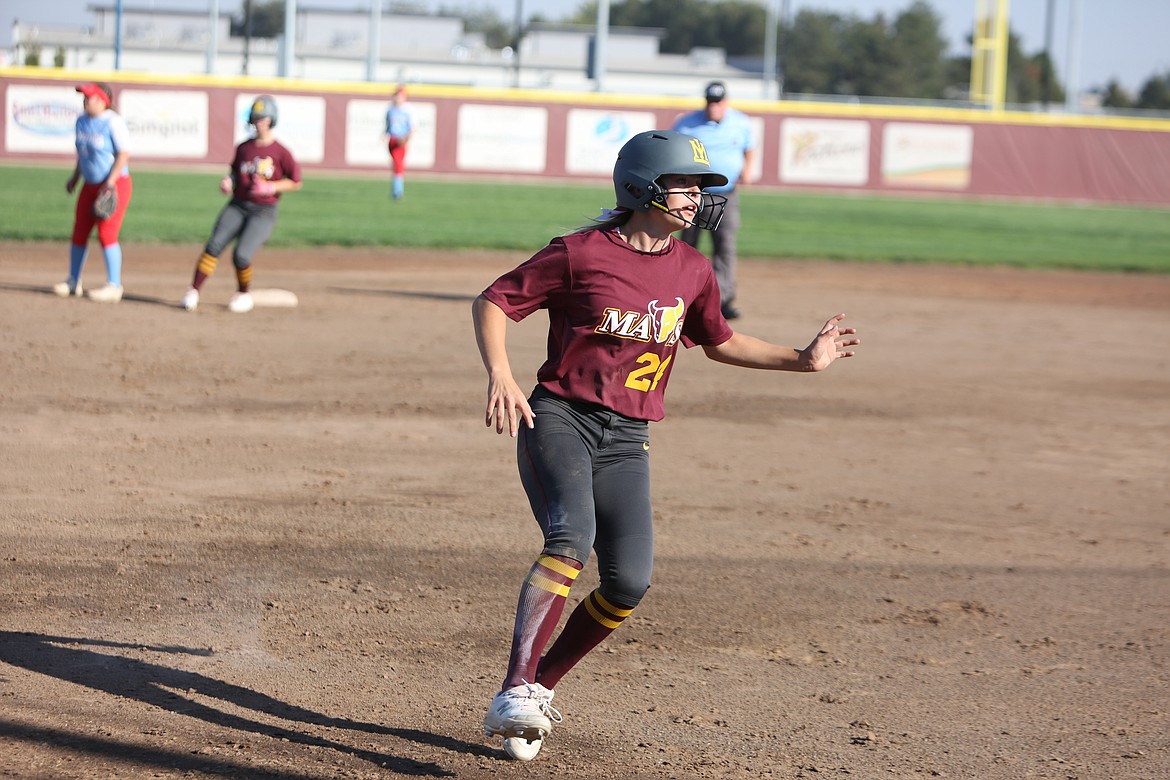 Moses Lake junior Kendall Reffett begins to slow down ahead of third base.