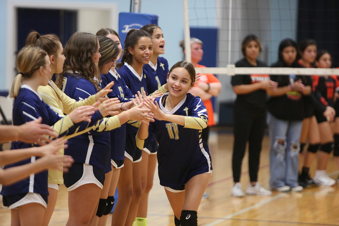 MLCA/CCS freshman Faith Rodriguez high-fives teammates during player introductions in Monday’s match against Entiat.