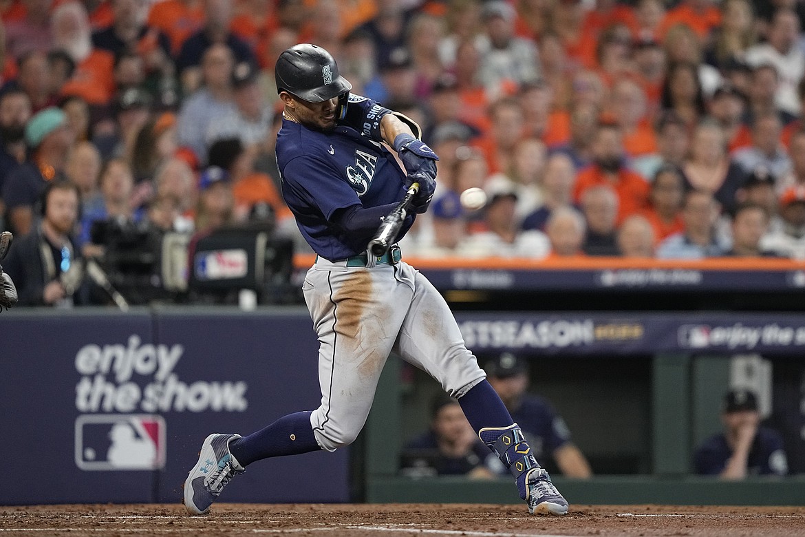 Seattle Mariners center fielder Julio Rodriguez (44) hits a two-run double against the Houston Astros during the second inning in Game 1 of an American League Division Series baseball game in Houston Tuesday.