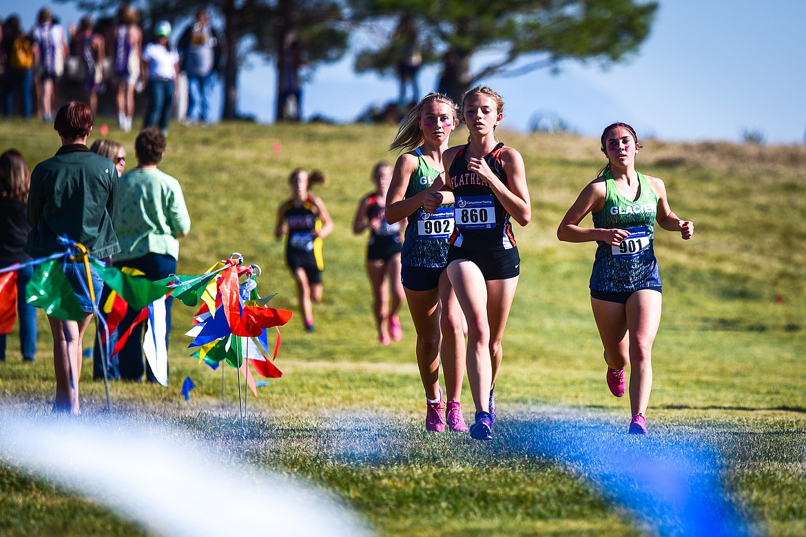 From left, Glacier's Alyssa Vollersten, Flathead's Lindy Porter and Glacier's Anna Tretter near the end of the first lap during the Glacier Invite at Rebecca Farm on Wednesday, Oct. 12. (Casey Kreider/Daily Inter Lake)