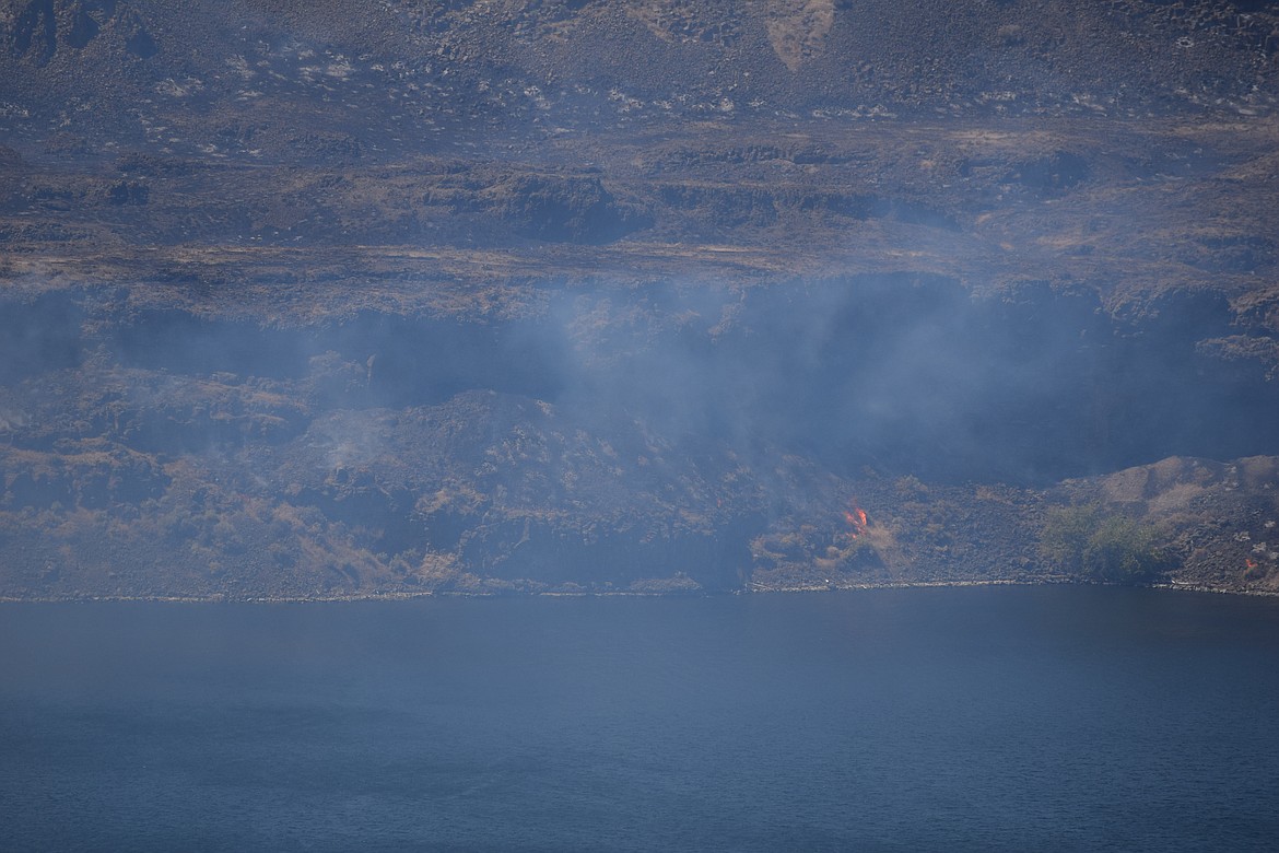 A fire burns along the Columbia River just north of Vantage earlier this year. While the Vantage fire is now out, several others continue to burn across the state.