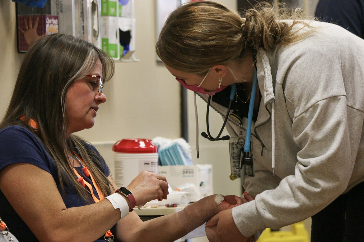 Medical staff treat a volunteer acting the part of a patient during Saturday’s training exercise.