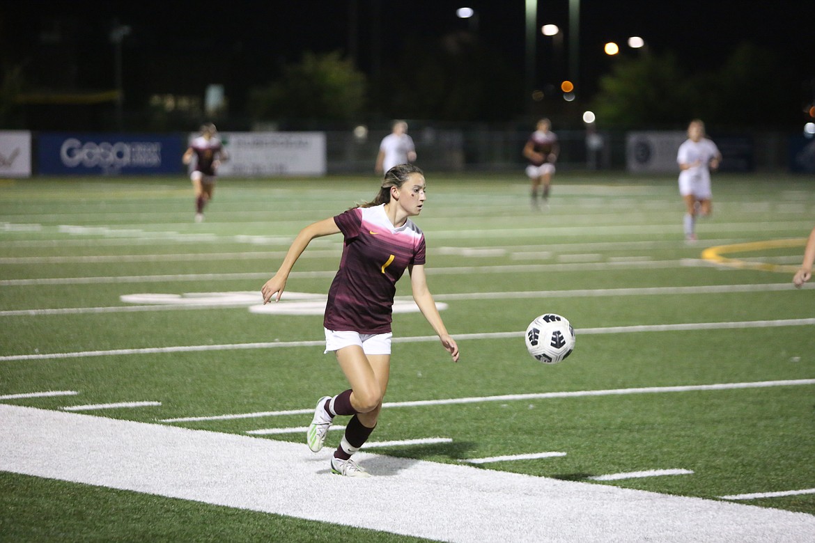 Moses Lake sophomore Maite Betes dribbles the ball upfield while looking for a teammate to pass to.