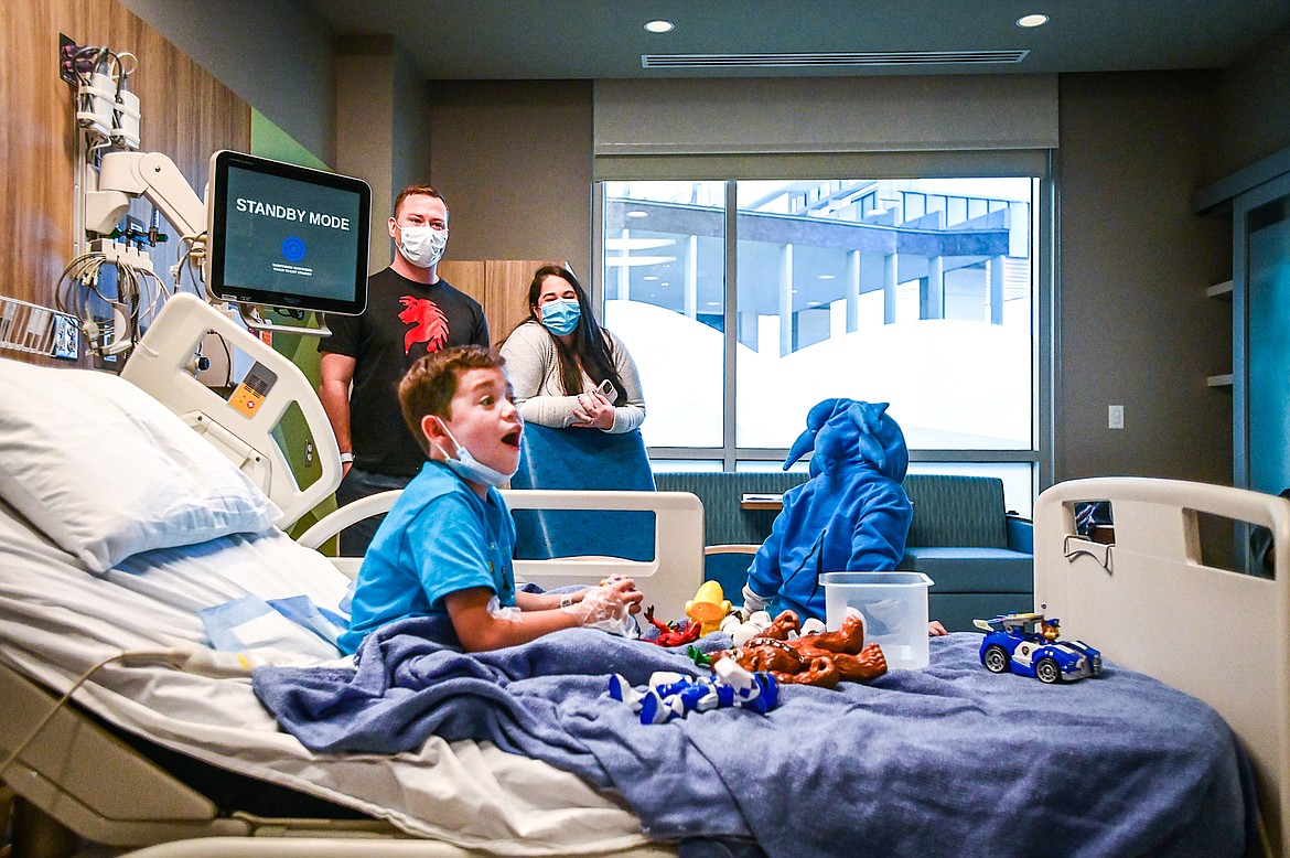 Cash Norwalt reacts as racks of Halloween costumes are wheeled into his room during the Spirit of Children visit at Logan Health Children's in Kalispell on Thursday, Oct. 13. The Child Life team at Logan Health Children's handed out costumes and treats donated by Spirit Halloween to allow children in the hospital the chance to celebrate Halloween. Spirit of Children supports Child Life Departments operating in local hospitals and in two years has raised over $49,000 for Logan Health Children’s. Behind Cash are his parents Cody and Nina. (Casey Kreider/Daily Inter Lake)