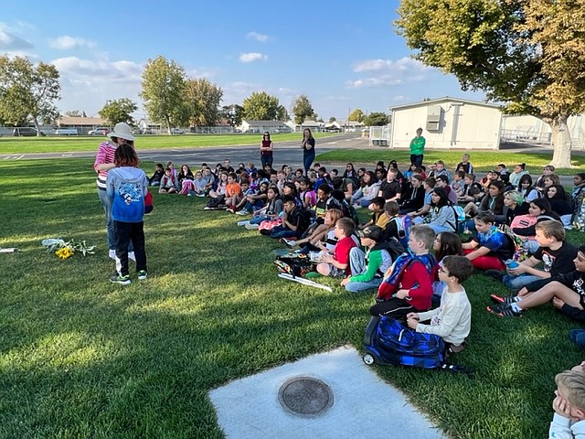 Gayle Talbot, president of the Central Basin Audubon Society, presents Kingston Studebaker with the Backyard Habitat Award at Lakeview Terrace Elementary School Sept. 30