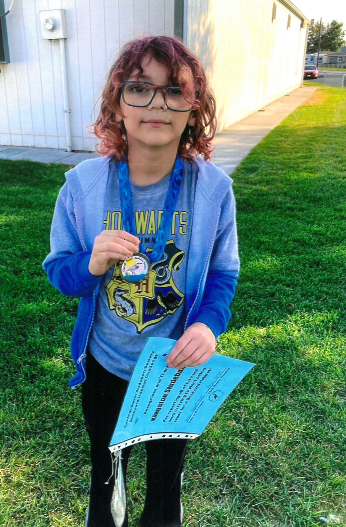 Kingston Studebaker shows off his Backyard Habitat Award Sept. 30.