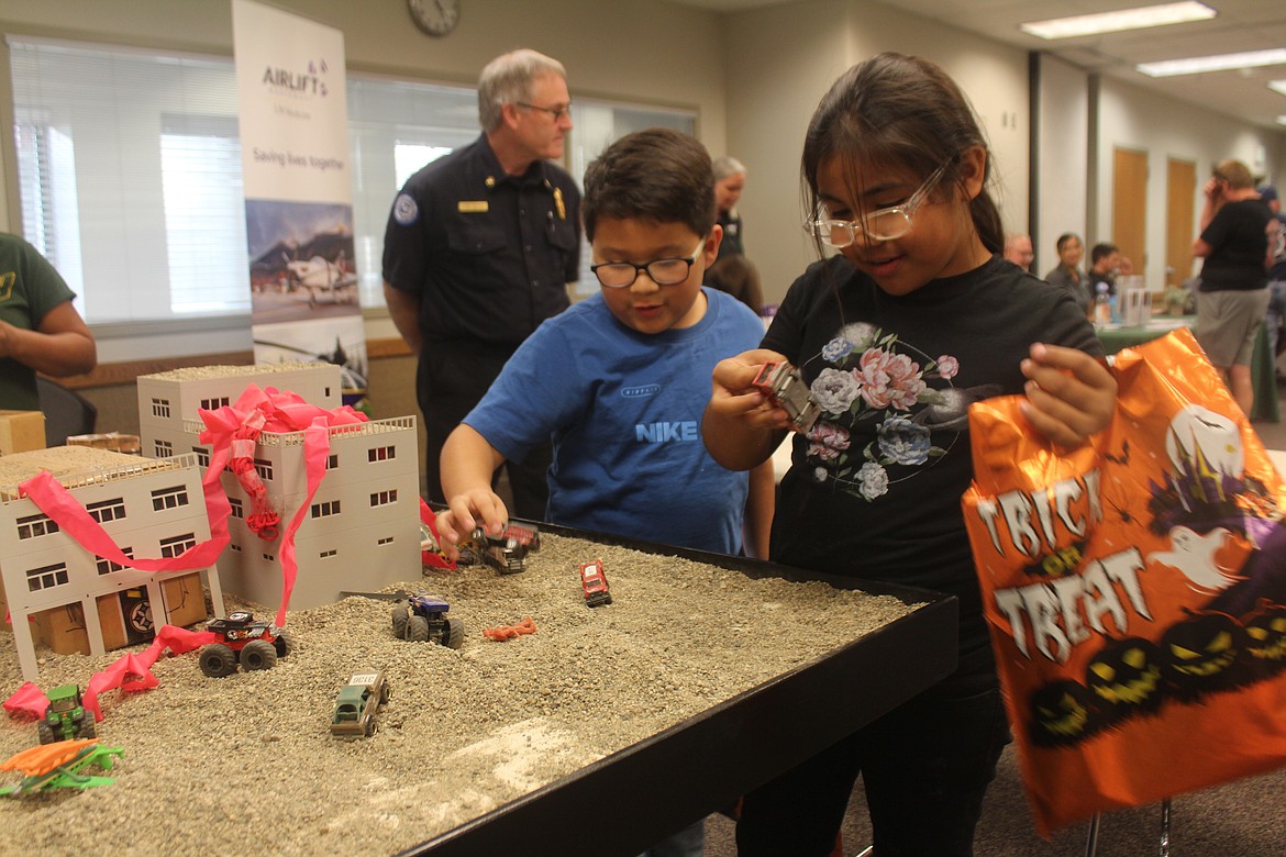 It may look like Alex Pacheco, left, and Giselle Lopez, right, are playing in a sandbox, but actually they’re playing on the table Grant County Fire District 3 uses for tabletop exercises. The children got a chance to try out the tabletop during the district’s annual open house Oct. 11; GCFD is celebrating its 80th anniversary this year.